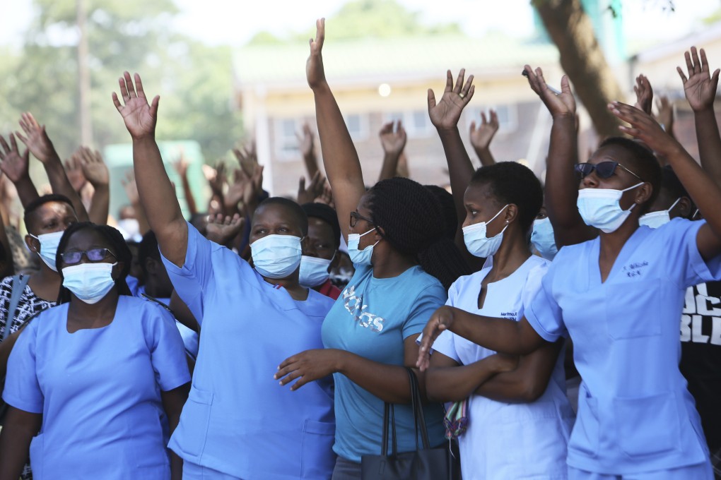 Zimbabwe nurses supporting a boycott at one of the country’s biggest public hospitals in Harare on Monday, after the health ministry scrapped a flexible working-hours system. Pandemic-related restrictions have added to the strains the country has felt under sanctions in place for almost two decades. Photo: AP