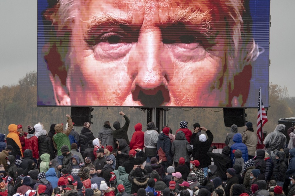 Supporters of President Donald Trump watch a video during a campaign event in Lansing, Michigan. Photo: AP