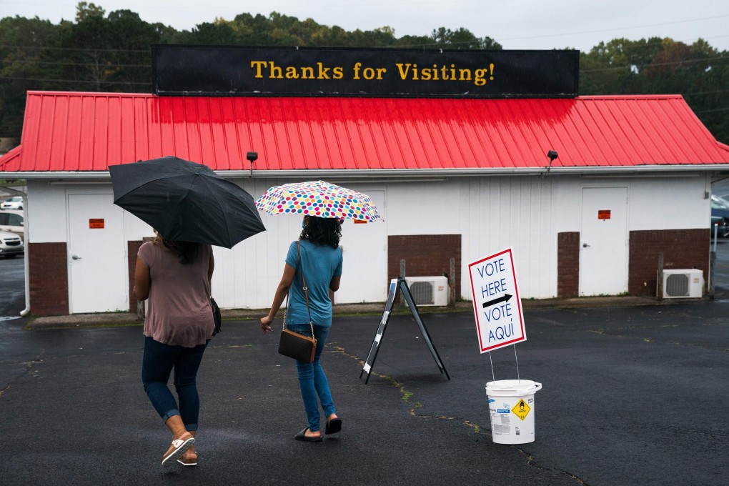 People leave an early voting location in Lawrenceville, Georgia, where Joe Biden and Donald Trump are neck and neck in the polls. Photo: AFP