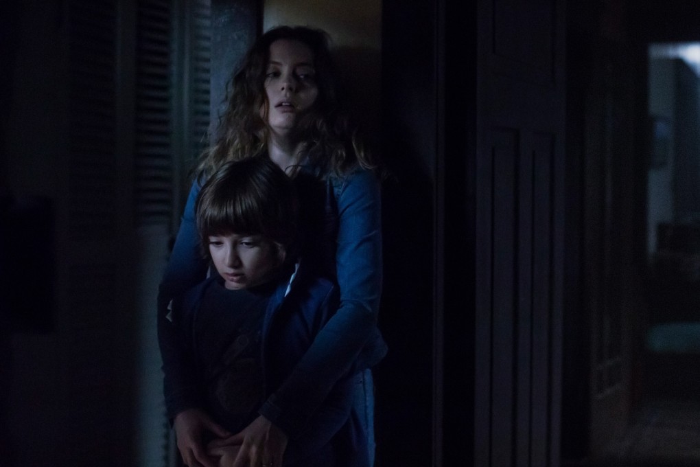 Azhy Robertson (front) and Gillian Jacobs in a scene from Come Play (category: IIA), directed by Jacob Chase and co-starring John Gallagher Jnr. Photo: Jasper Savage/Amblin Partners/Focus Features