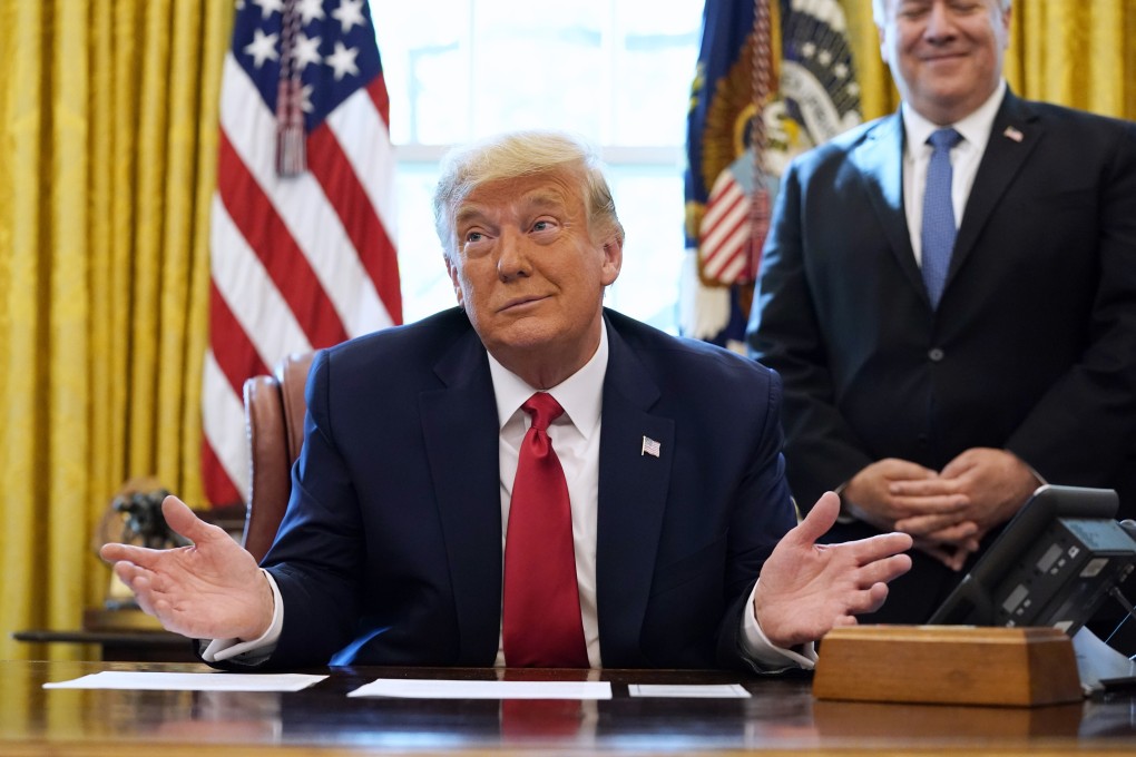 President Donald Trump on a phone call with the leaders of Sudan and Israel, as Secretary of State Mike Pompeo looks on, in the Oval Office on October 23. Photo: AP