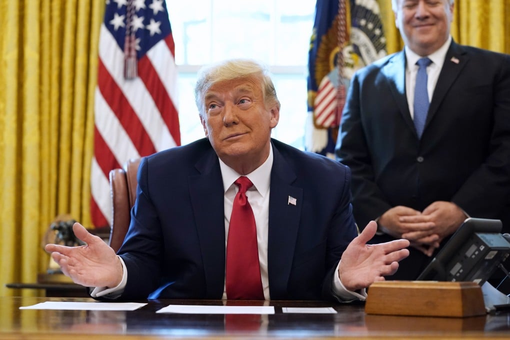 President Donald Trump on a phone call with the leaders of Sudan and Israel, as Secretary of State Mike Pompeo looks on, in the Oval Office on October 23. Photo: AP
