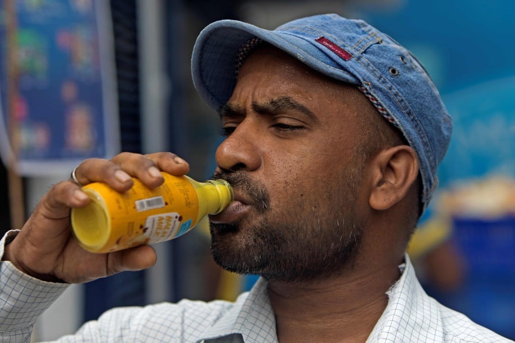 A customer drinks Mother Dairy’s Haldi Milk (turmeric milk) as a preventive measure against the spread of the coronavirus. Photo: AFP