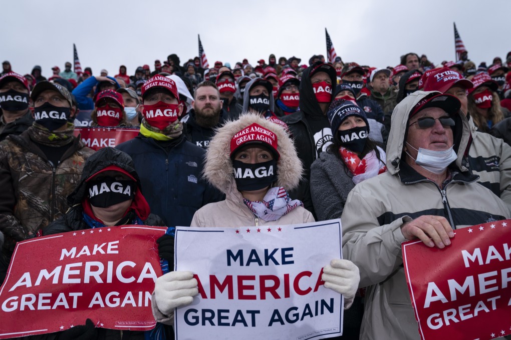 Supporters of President Donald Trump listen to his speech during a campaign rally at Capital Region International Airport in Lansing, Michigan, on October 27. Trump has repeatedly refused to commit to accepting the outcome of a vote that opinion polls forecast he is likely to lose. Photo: AP