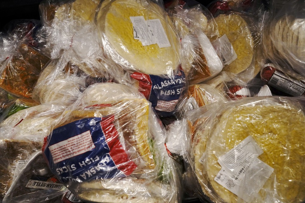 Packages of frozen food are seen at a US food pantry this month. The SARS-CoV-2 pathogen that causes Covid-19 could be ‘hitching a ride’ on food, a doctor in Singapore has warned. Photo: Reuters