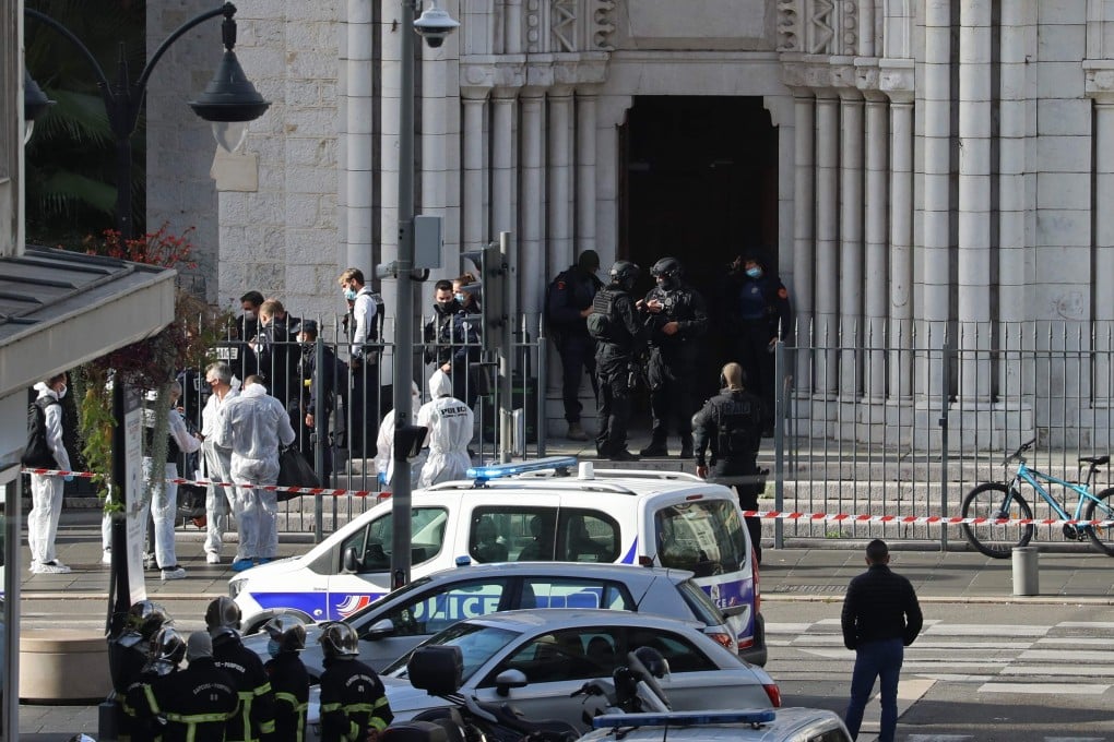 Members of France’s elite tactical police unit enter the Basilica of Notre-Dame de Nice after a knife attack on Thursday. Photo: AFP/DPA