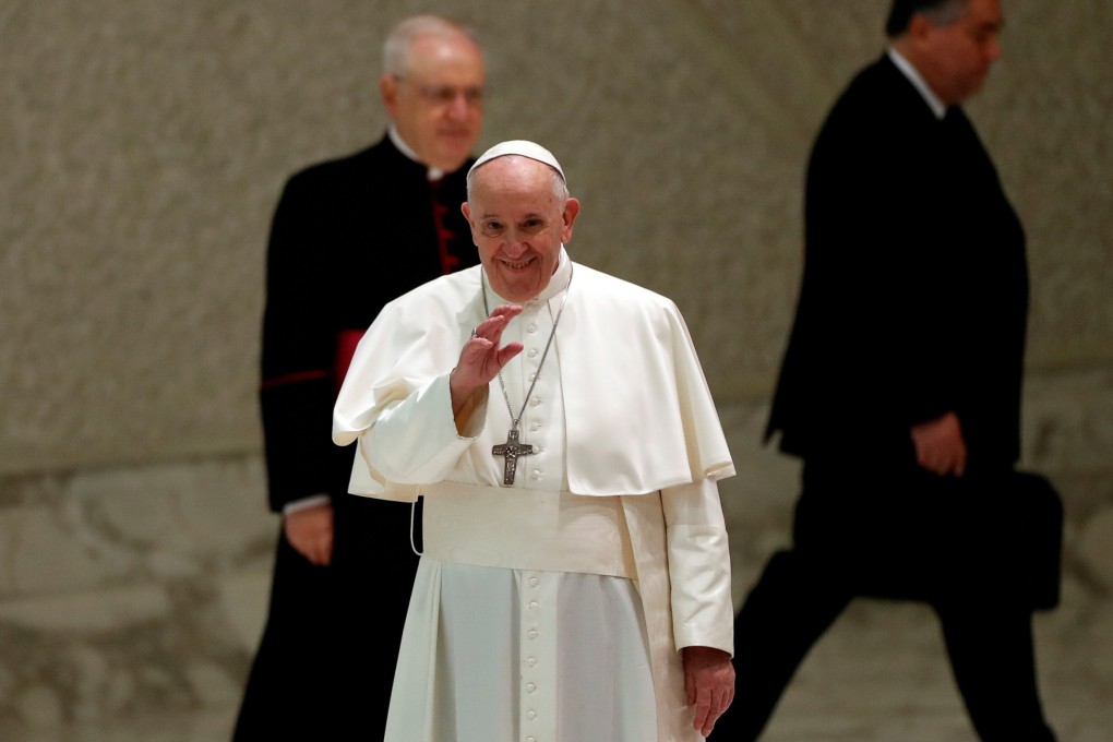 Pope Francis greets people as he arrives at Aula Paolo VI for the weekly general audience at the Vatican on Wednesday. Photo: Reuters