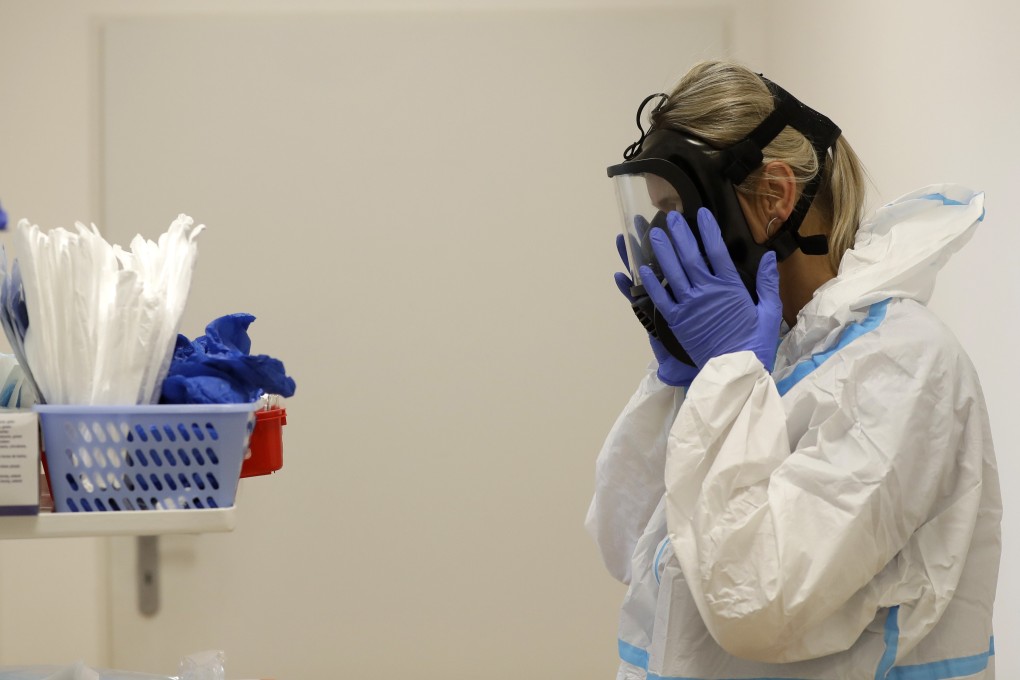 A health care worker puts on personal protective equipment before tending to Covid-19 patients at a hospital in Kyjov, in the Czech Republic, on October 22. Photo: AP