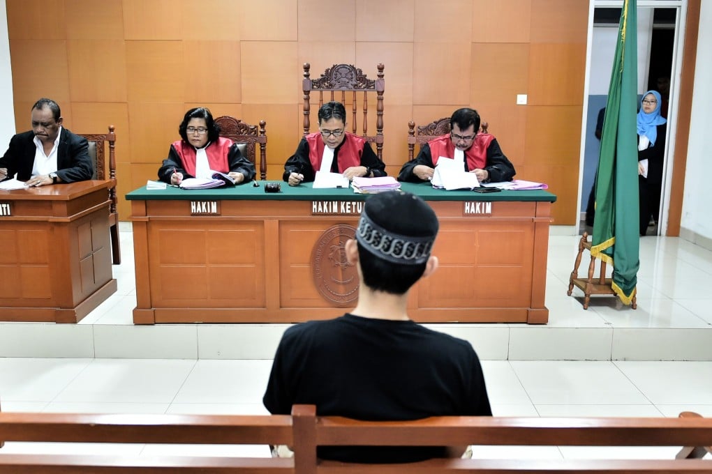 A suspected terrorist appears in court. Indonesia needs a stronger national effort to profile former extremists to persuade potential recruits to pause and think again before joining the cause. Photo: AFP