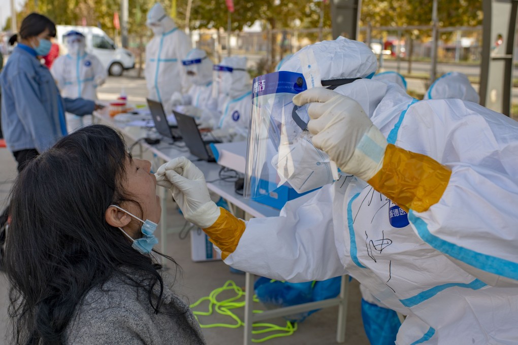 A medical worker collects a sample for nucleic acid Covid-19 testing in Shufu county, Kashgar Prefecture, in northwest China’s Xinjiang Uygur autonomous region on October 26. Rapid, widespread testing of residents has been one of the building blocks of China’s successful approach to containing the pandemic. Photo: Xinhua