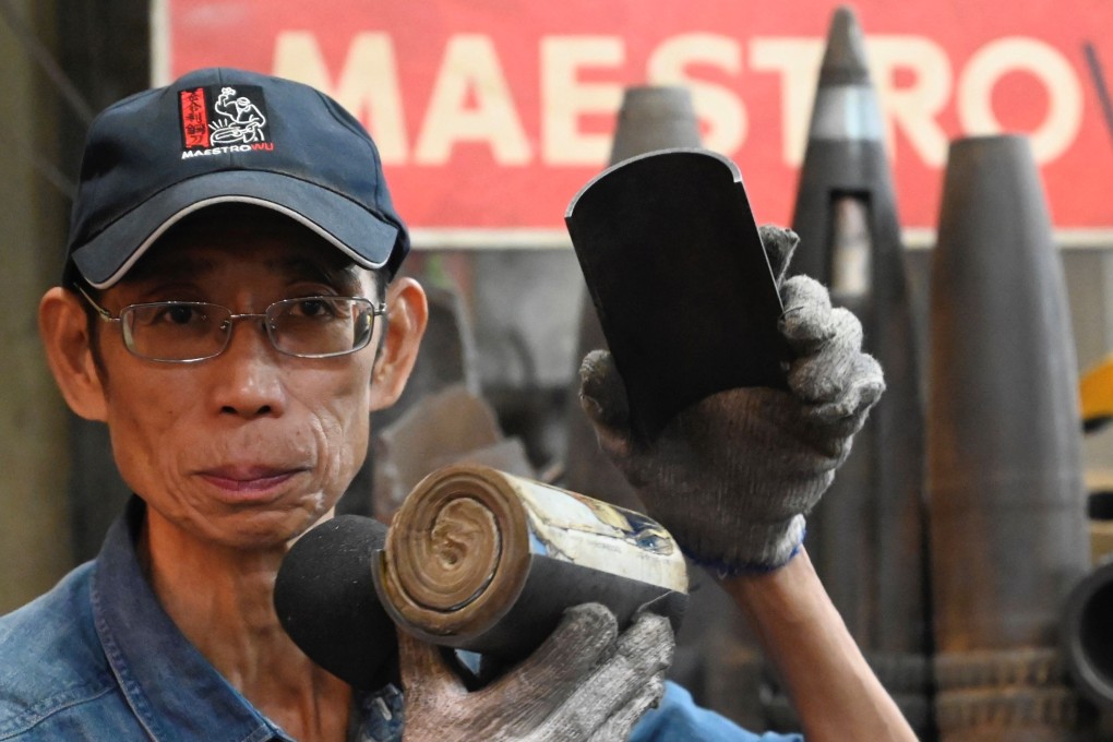 Blacksmith Wu Tseng-dong, owner of a knife factory, shows an artillery shell case containing communist Chinese propaganda, which was fired decades ago from Xiamen on the mainland at Taiwan’s Quemoy island. Photo: AFP