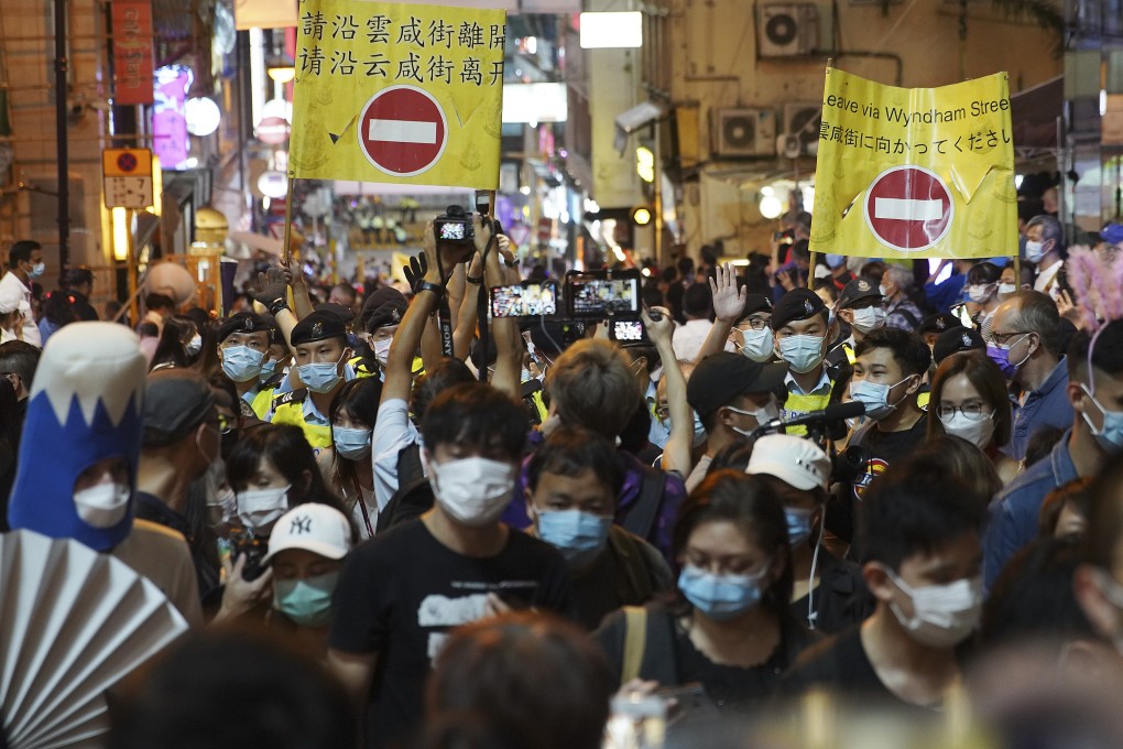 Police officers call for crowds to leave Lan Kwai Fong on Halloween night. Photo: Winson Wong