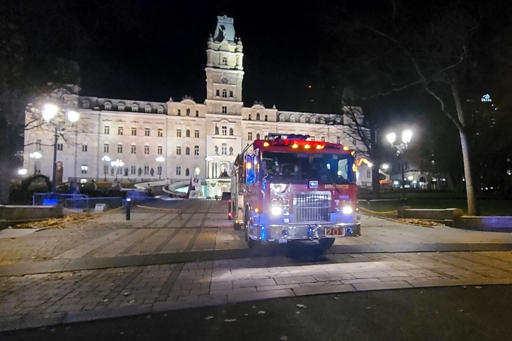 A firefighter truck is parked in front of the National Assembly of Quebec, in Quebec City, early on November 1 after two people were killed by a sword-wielding suspect dressed in medieval clothing. Photo: AFP