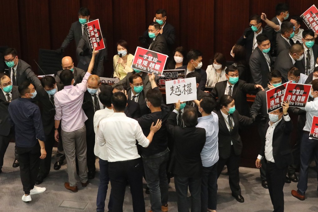Lawmakers protest during a House Committee meeting at Legco in May, calling for pro-government lawmaker Starry Lee (seated, in yellow coat) to step down. Photo: Dickson Lee