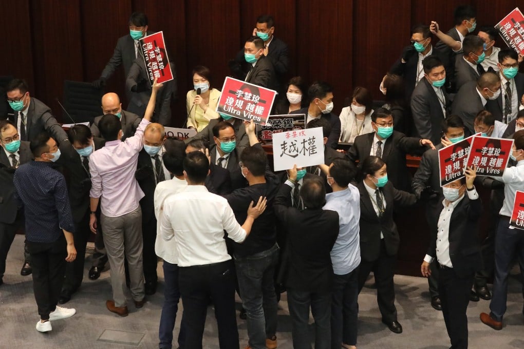 Lawmakers protest during a House Committee meeting at Legco in May, calling for pro-government lawmaker Starry Lee (seated, in yellow coat) to step down. Photo: Dickson Lee