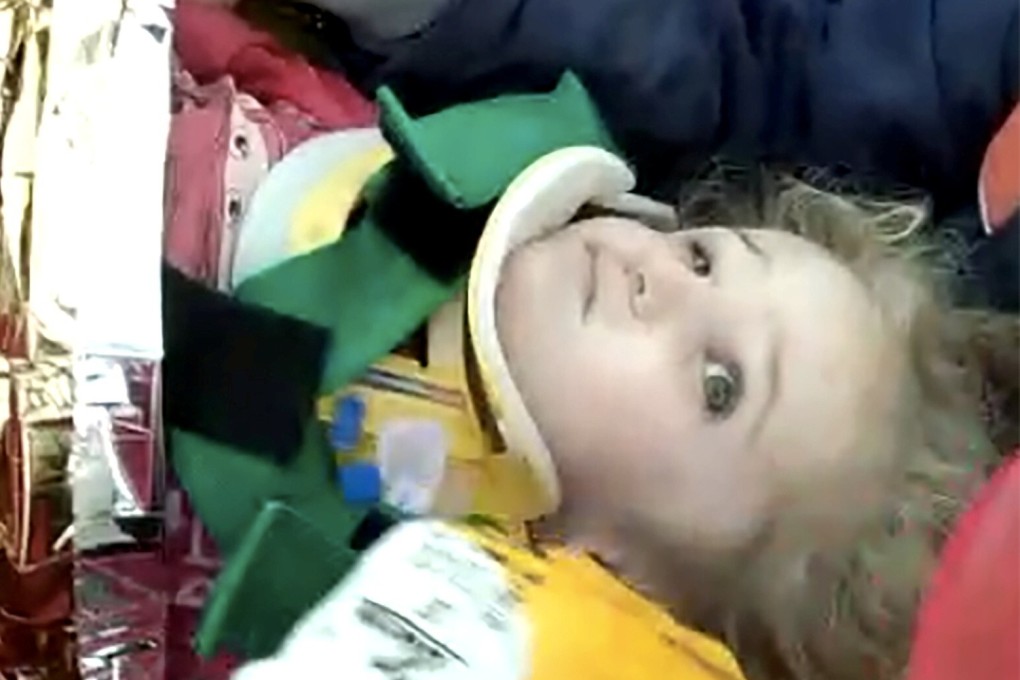 Rescuers carry Elif Perincek, a three-year-old survivor, out of a collapsed building in Izmir, Turkey. Photo: Reuters