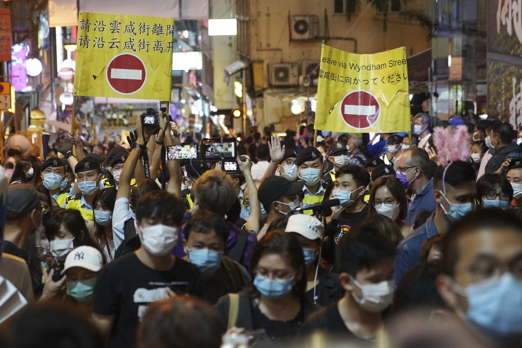 Police officers call for crowds to leave Lan Kwai Fong on Halloween night. Photo: Winson Wong