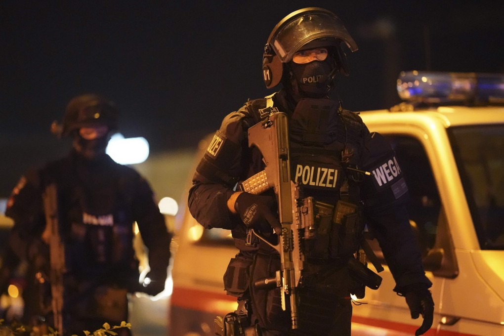 A heavily armed policeman stands guard at Schwedenplatz in Vienna on Monday, following a shooting in the city centre. Photo: AFP