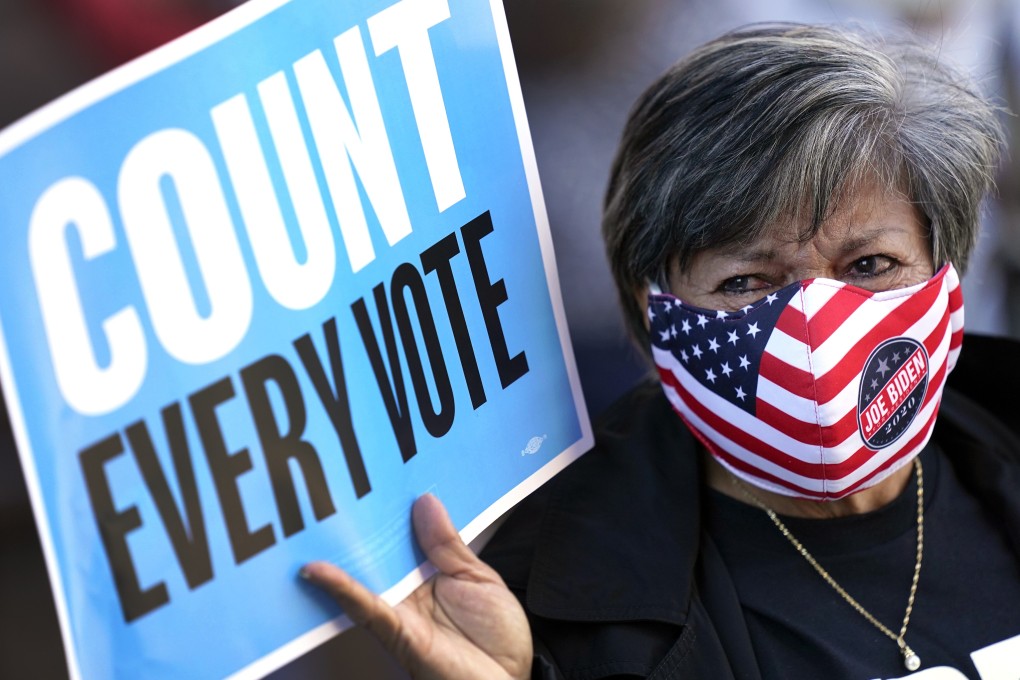 Volunteer election poll worker Cecilia Chaboudy-Dow joins demonstrators as they stand across the street from the federal courthouse in Houston on Monday. Photo: AP