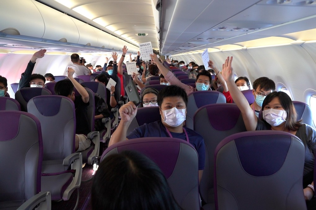 Passengers on board the HK Express flight play a game with crew members. Photo: Handout