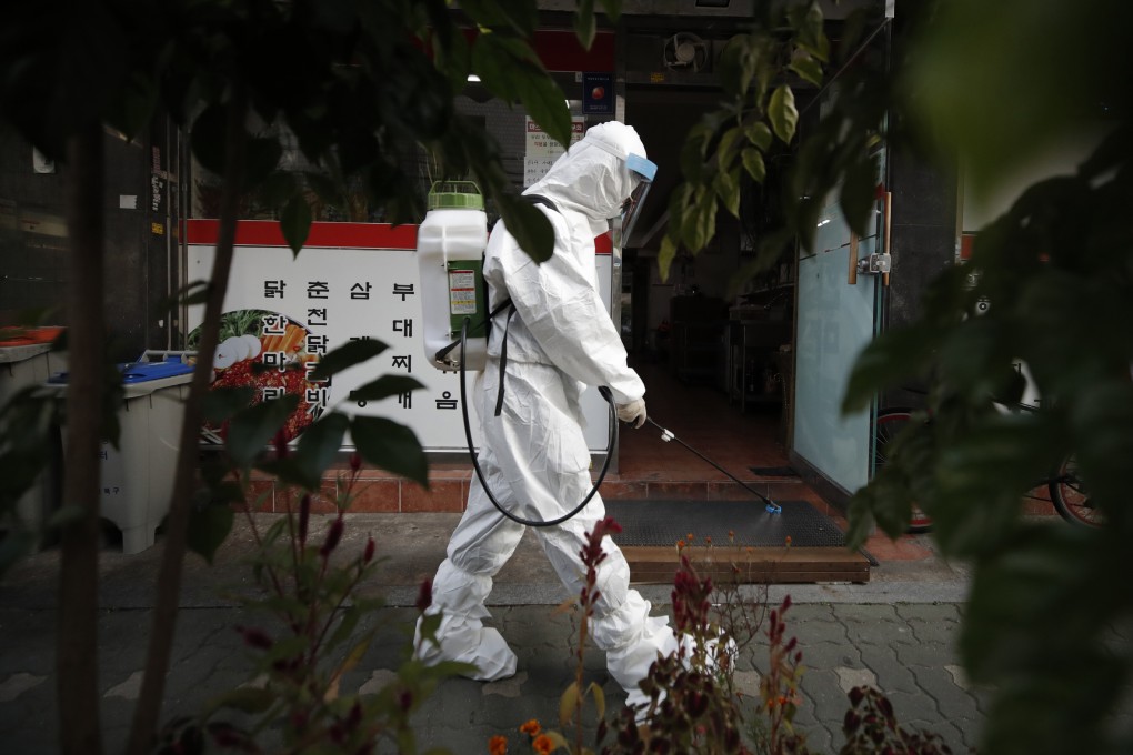 A worker sprays disinfectant to help curb the spread of the coronavirus in Seoul. Photo: AP