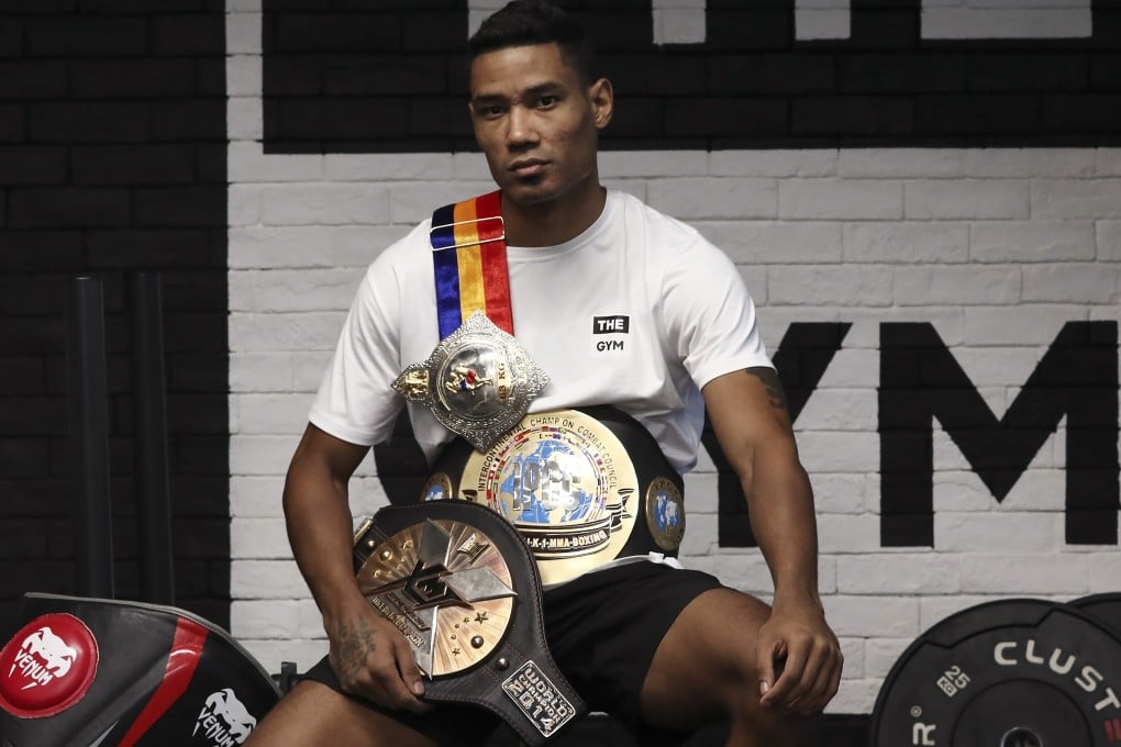 Muay Thai coach Jeferson Oliveira with his three belts: Xtreme Muay Thai world champion (2014), IPCC Intercontinental champion (2018) and Thapae Boxing Stadium (2019). Photo: Jonathan Wong
