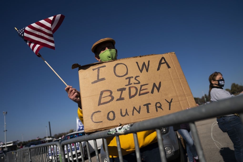 A supporter waves an American flag as Democratic presidential nominee Joe Biden speaks during a drive-in campaign rally at the Iowa State Fairgrounds on Friday. Photo: Getty Images/AFP