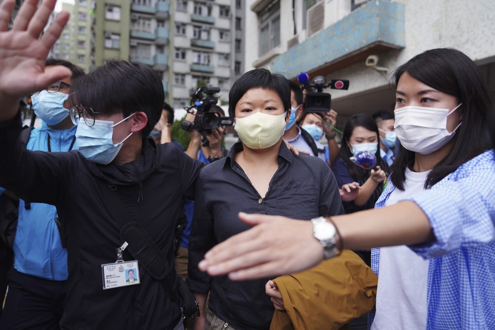 RTHK contributor Choy Yuk-ling is arrested on suspicion making a false declaration when searching for personal details of car owners in the government database, on Tuesday. Photo: Sam Tsang