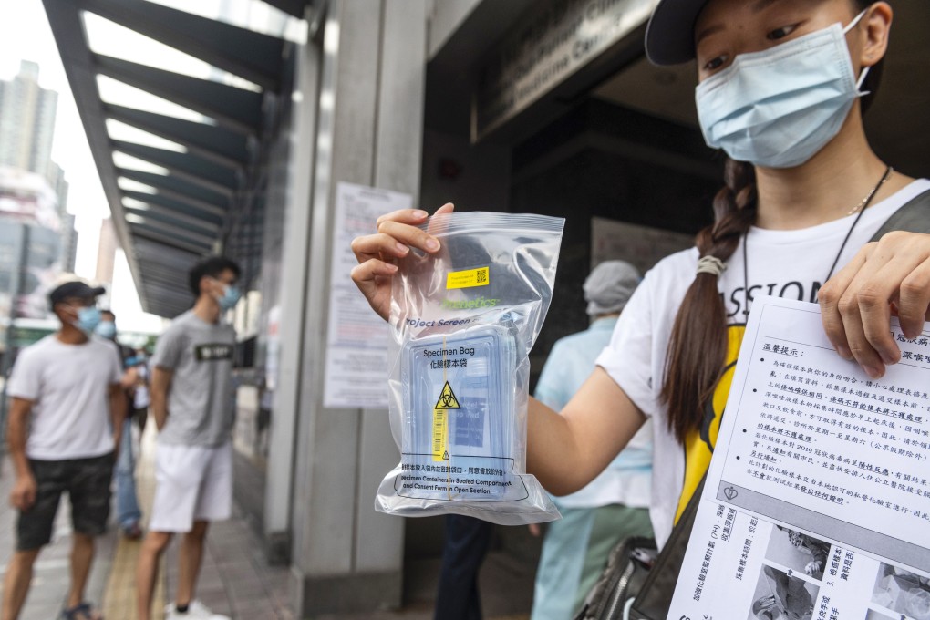 A resident shows a free Covid-19 test kit distributed by the government in Hong Kong’s Sham Shui Po neighbourhood. Photo: EPA-EFE