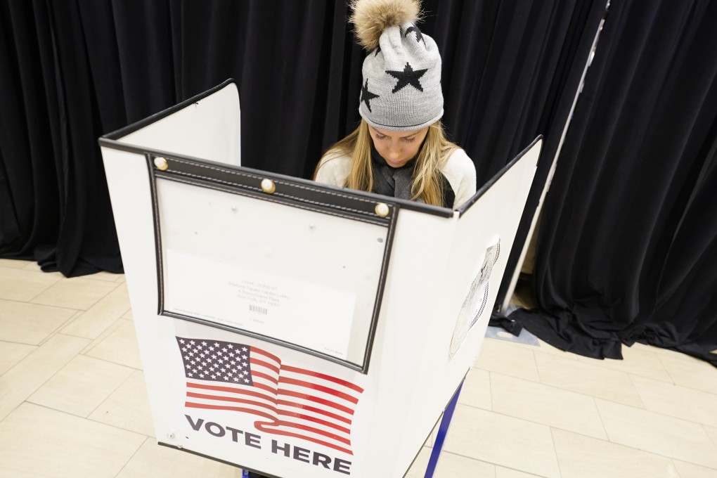 A woman marks her ballot during the first hour of voting in New York on Tuesday, November 3. Photo: AP