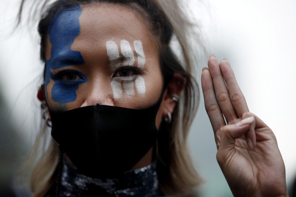 A Thai pro-democracy activist flashes the three-finger salute during an anti-government protest in Bangkok, Thailand, on October 25. Fans of K-pop groups like BTS, Super Junior, Exo, Blackpink and Shinee have emerged as a political force in the country’s recent protests. Photo: EPA