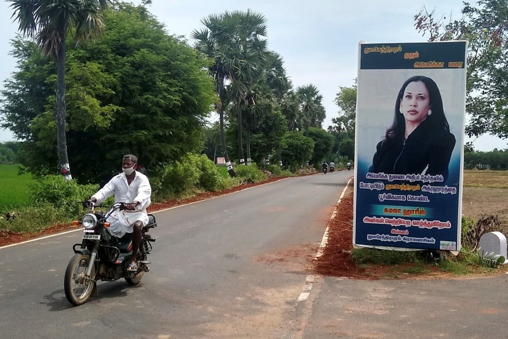 A man drives past a banner of US Democratic vice-presidential nominee Kamala Harris at the village of Thulasendrapuram, Tamil Nadu, India. Photo: Reuters