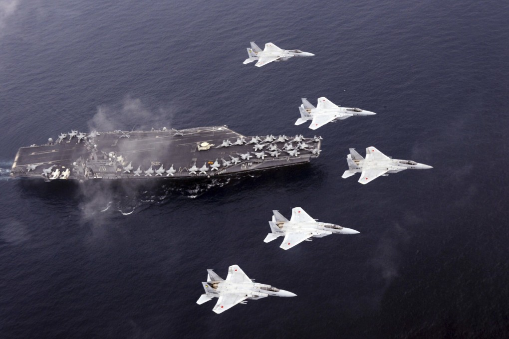 Japan Air Self-Defence Force's F-15 fighter jets fly over the USS Carl Vinson during a Japan-US joint training exercise in the Sea of Japan. Photo: AP