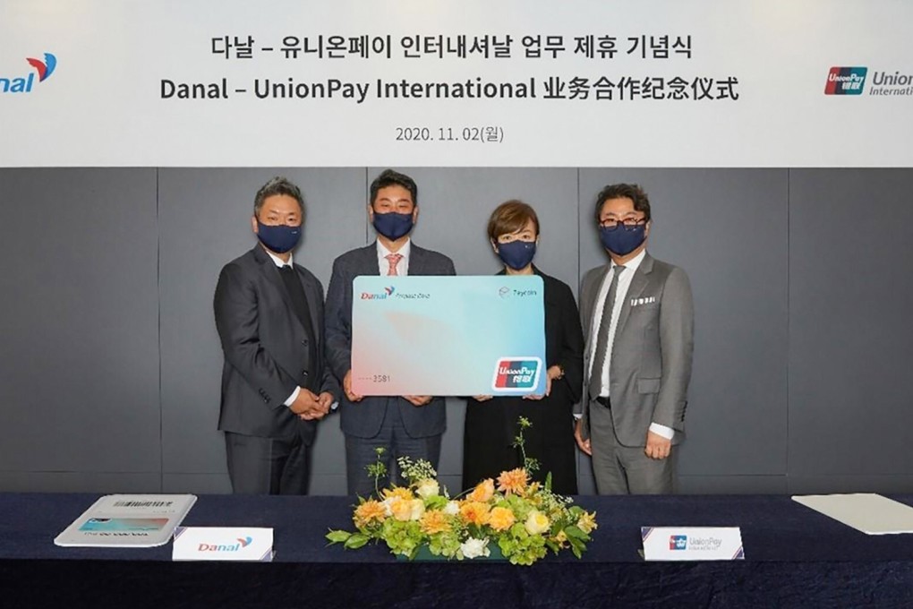 Executives from China's UnionPay and Korean payment firm Danal ink the deal for a prepaid card that accepts cryptocurrency. Photo: Handout