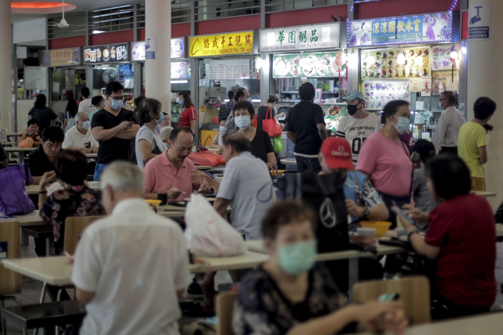 Customers purchase food at a hawker center in Singapore. Photo: EPA