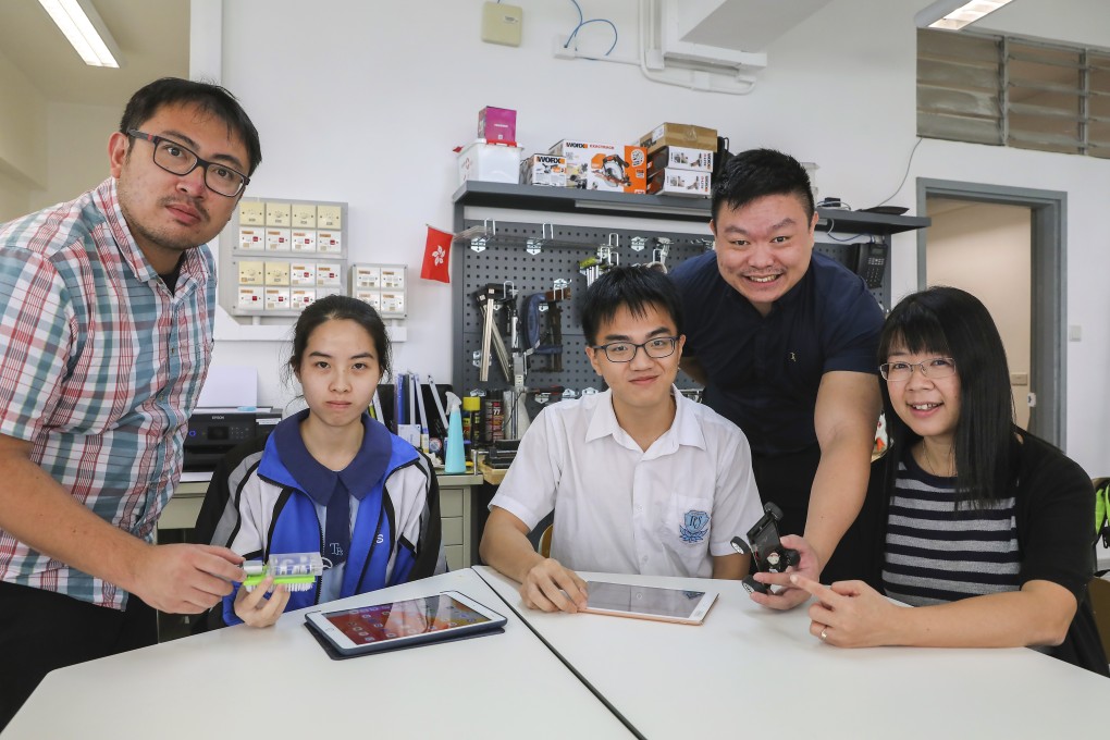 Teachers Hung Kam-chuen (left), Cliff Yeung, English panel head, and Chu Yuen-ching, technology and living panel head, with students at Tsang Pik Shan Secondary School. Photo: K. Y. Cheng