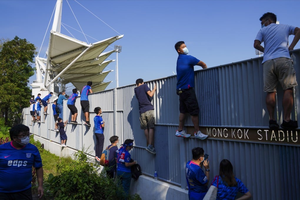 Fans were reduced to watching games by climbing fences when spectators were banned from stadiums because of the Covid-19 pandemic. Photo: Sam Tsang
