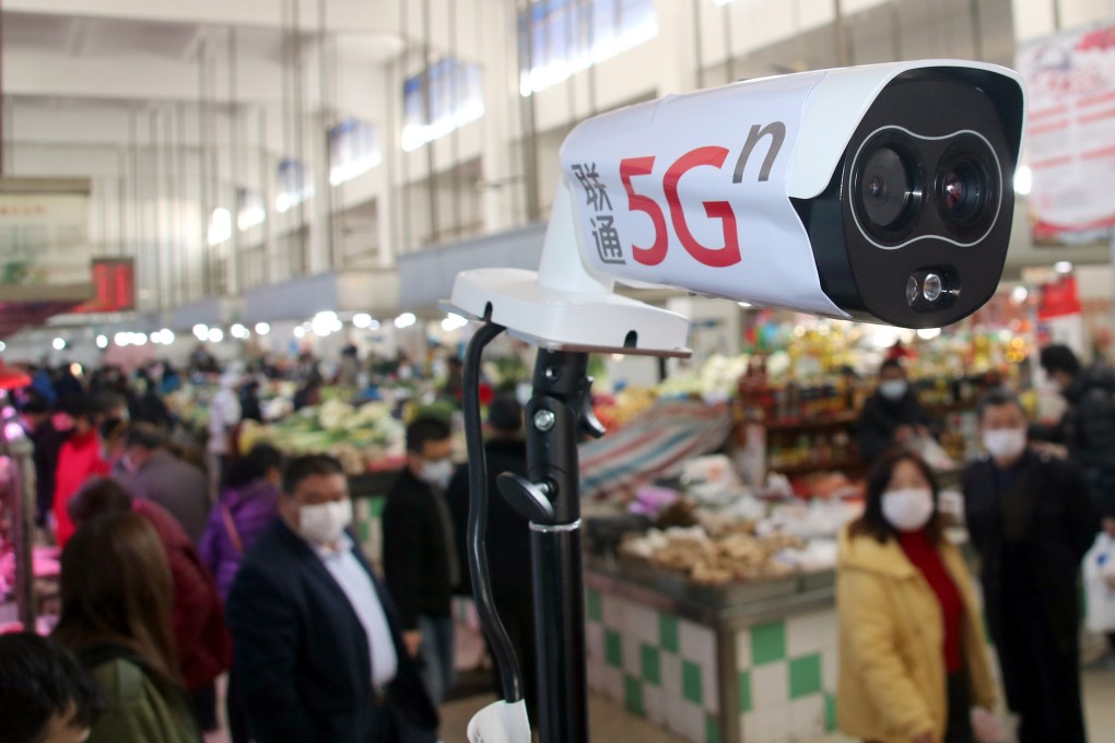 A new thermal temperature detector using 5G scans customers at a market in Suzhou, in China’s Jiangsu province, on February 20. When these devices detect anyone with a high temperature, they send out warning signals and identify the person using facial recognition technology. Photo: Imaginechina