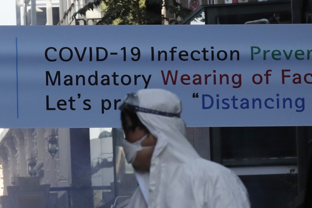 A health official seen in protective gear in Seoul. Photo: AP