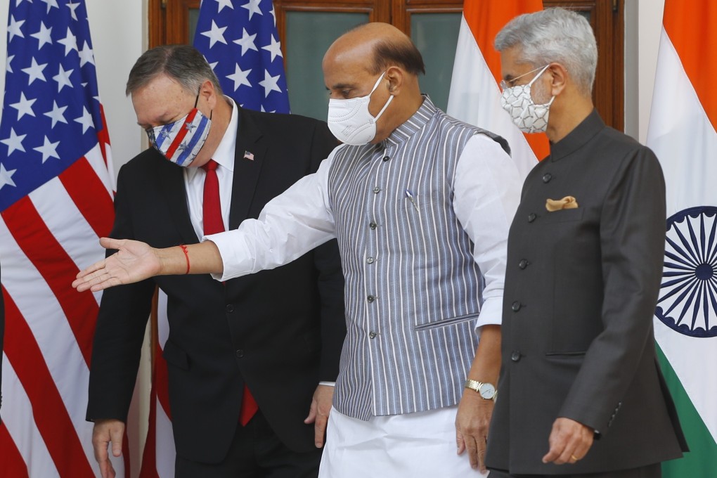 Indian Defence Minister Rajnath Singh (centre) gestures towards US Secretary of State Mike Pompeo. Photo: AP