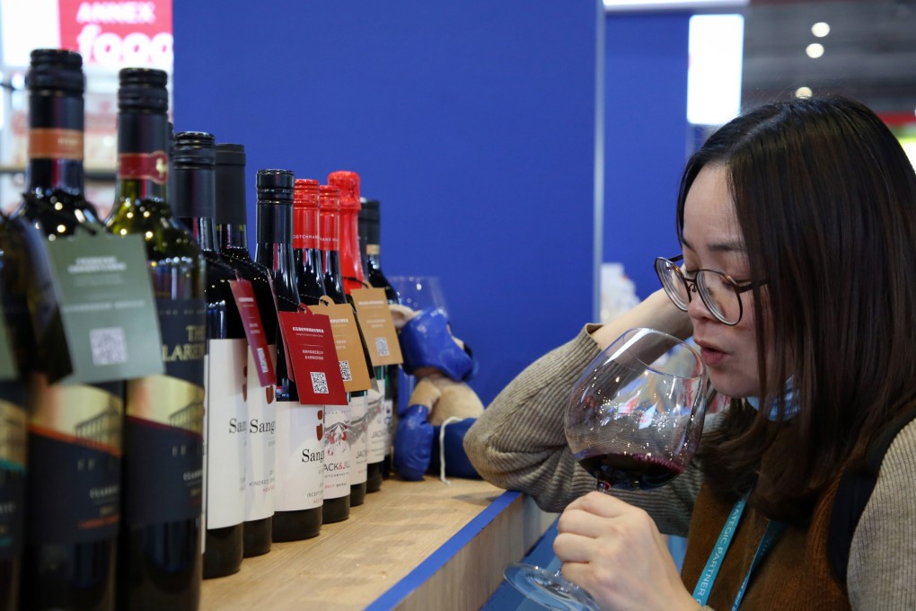 A woman samples red wine from Australia at the third annual China International Import Expo in Shanghai on Thursday. Photo: AFP