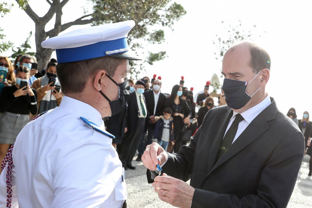 French Prime Minister Jean Castex awards a local police officer during a ceremony to pay tribute to the victims of a knife attack in Nice. Photo: EPA-EFE