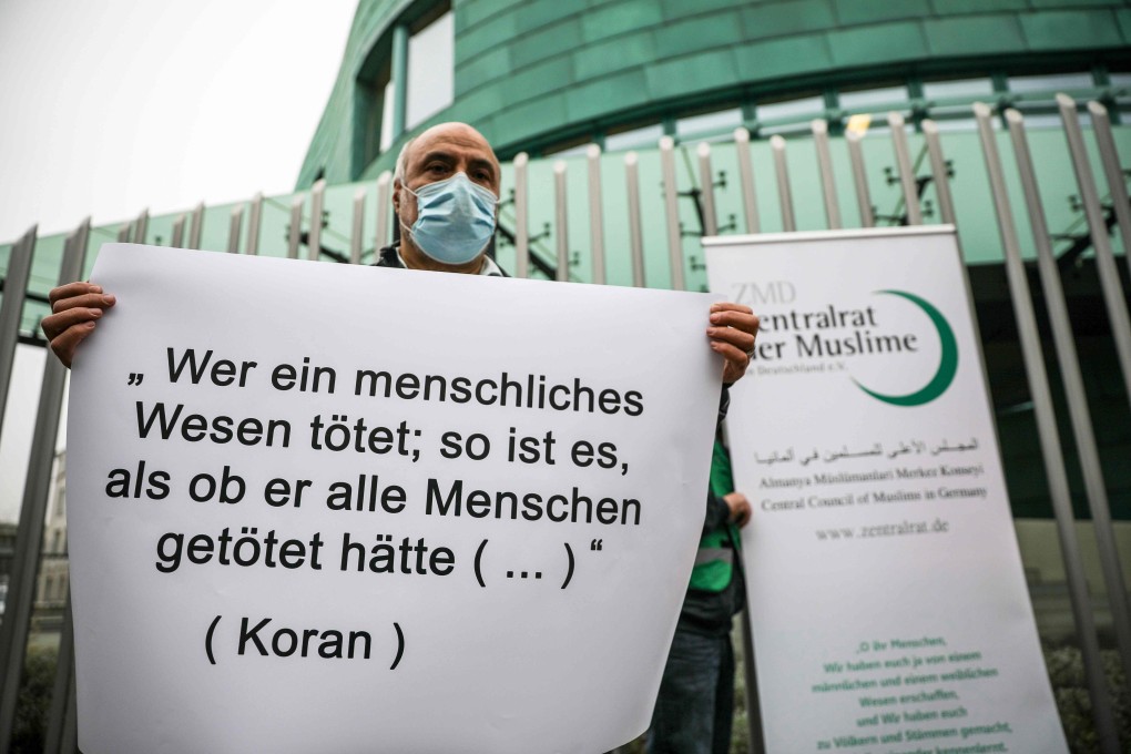 A placard with a verse from the Koran reading “Whoever kills a human being, it is as though he had killed all mankind …” during a vigil outside the Austrian embassy in Berlin on Friday. Photo: AFP