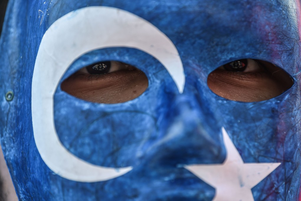 A protester in Istanbul wears a mask with the colours of the East Turkestan flag in 2018. ETIM is seeking an independent Islamic state in Xinjiang called East Turkestan. Photo: AFP
