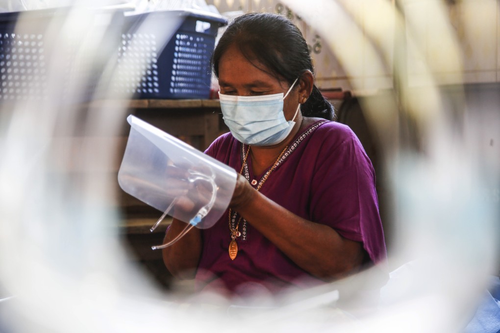 A volunteer prepares face shields to prevent the spread of coronavirus at the Mingan ward polling station in Sittwe, Rakhine, Myanmar on Saturday. Photo: EPA-EFE