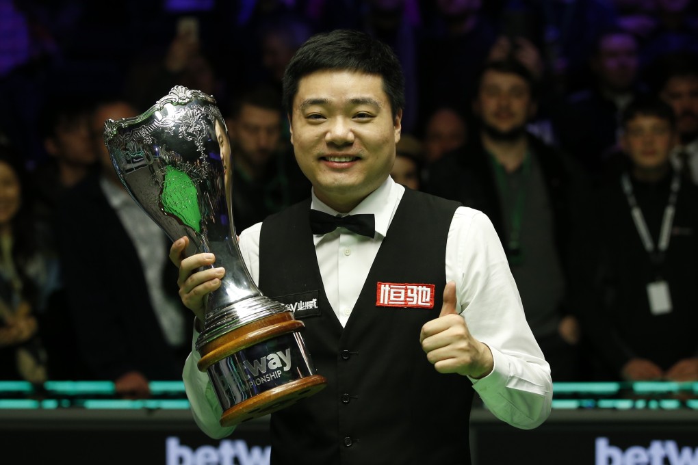 China’s Ding Junhui holds the trophy after winning the 2019 UK Championship with victory over Stephen Maguire in the final. Photo: Xinhua