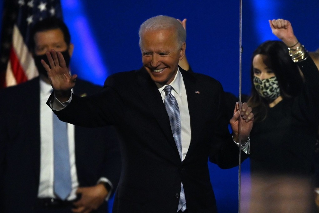US President-elect Joe Biden, flanked by his daughter Ashley, waves after delivering remarks in Wilmington, Delaware after being declared the winner of the presidential election. (Photo: AFP