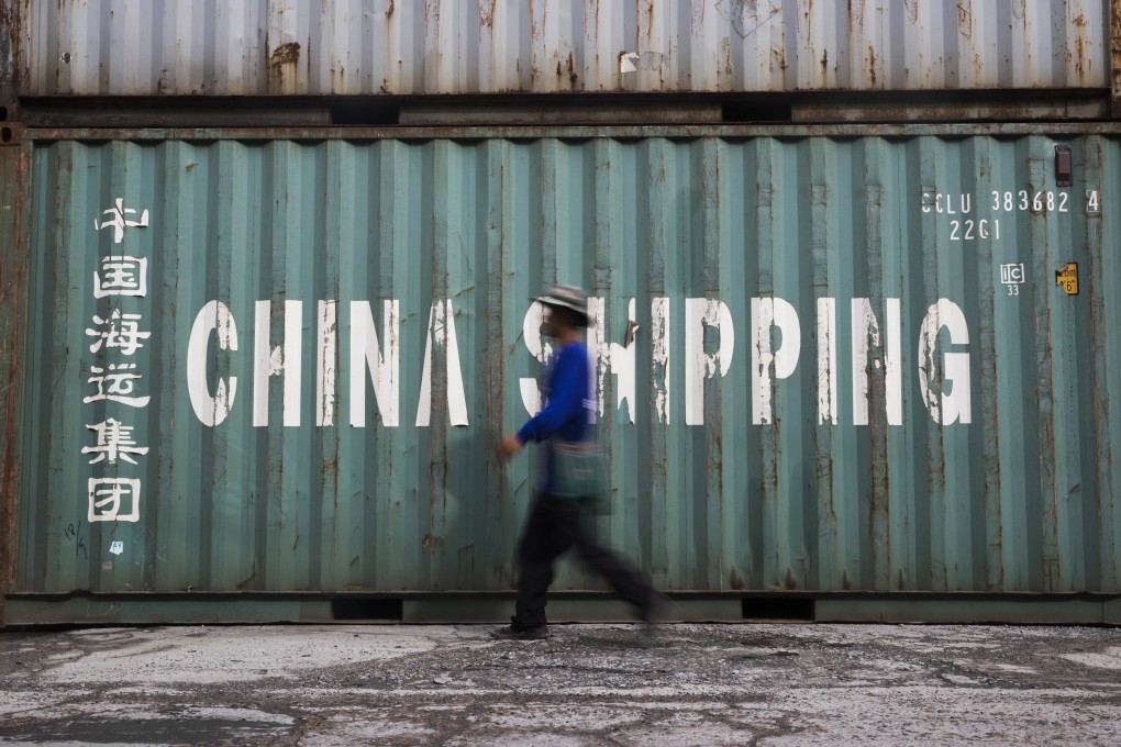 A worker passes a China Shipping Group container at a depot in Bangkok, Thailand. Photo: Bloomberg