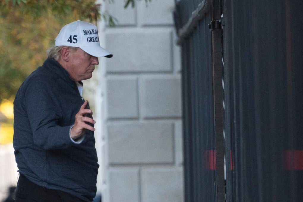 President Donald Trump returns to the White House from playing golf. Photo: AFP