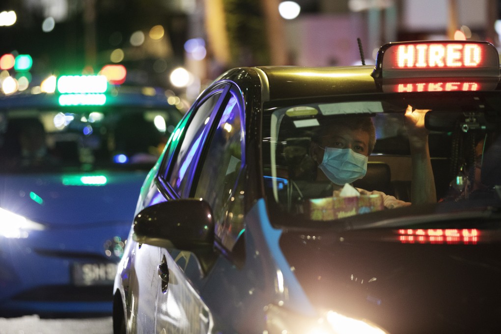 A taxi driver wearing a face mask waits at a traffic light in the Central Business District area in Singapore. Photo: EPA